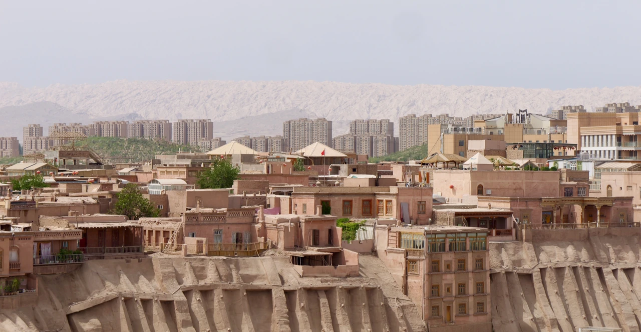 Earth-toned low-rise buildings with taller apartment blocks in the distance.