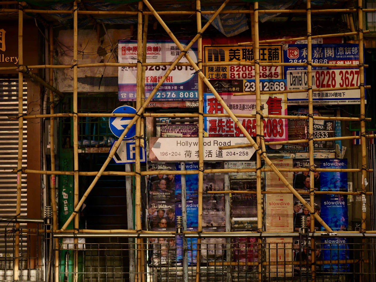 A dense grid of scaffolding and colourful signs.