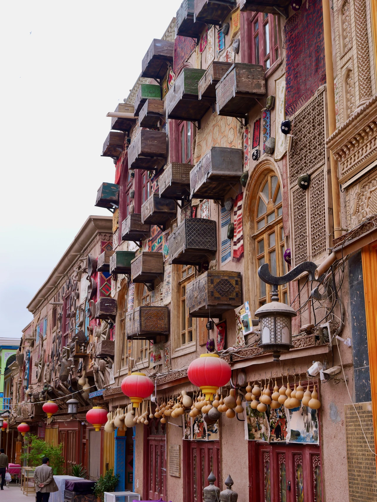 Decorated balconies and hanging lanterns on a tall building.